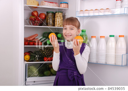 Beautiful  girl near the Fridge with healthy food. 84539035