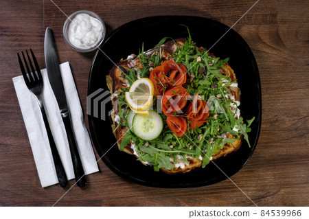 Smoked salmon salad on a black bowl full of delicious 84539966