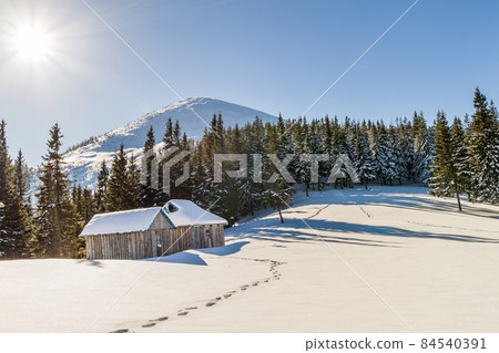 Beautiful winter landscape in the mountains with snow path in steppe and small little houses. Happy New Year celebration concept. 84540391