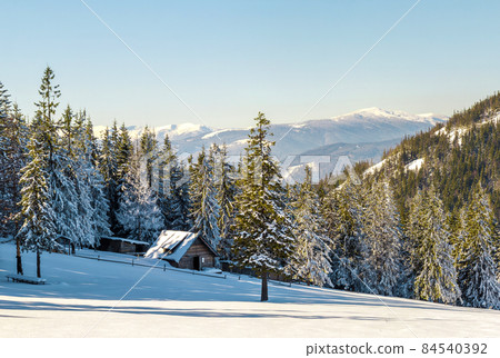 Beautiful winter landscape in the mountains with snow path in steppe and small little house. Happy New Year celebration concept. Beautiful winter landscape in the mountains with snow path in steppe and small little house. Happy New Year celebration concept. 84540392