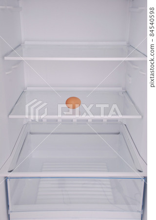 One eggs in open empty refrigerator. One eggs in open empty refrigerator. 84540598