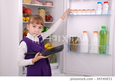 Beautiful girl near the Fridge with healthy food. Beautiful girl near the Fridge with healthy food. 84540651