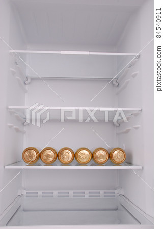 Six metal beer cans inside in empty clean refrigerator 84540911