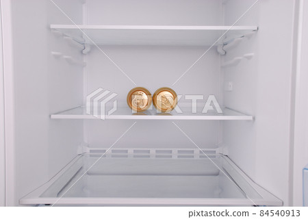 Two metal beer cans inside in empty clean refrigerator Two metal beer cans inside in empty clean refrigerator 84540913