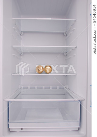 Two metal beer cans inside in empty clean refrigerator 84540914