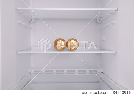 Two metal beer cans inside in empty clean refrigerator 84540916