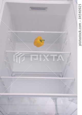 One pepper in open empty refrigerator. 84540925