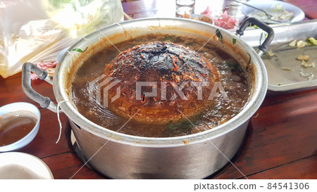 The buffet is grilled on a charcoal grill using a pan. What was left on the pan was burning black. In Thai it is called Moo Krata. 84541306