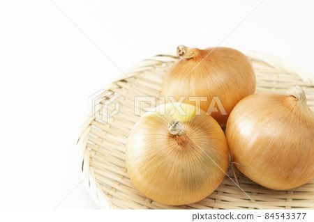 Onion in a colander white background Onion in a colander white background 84543377