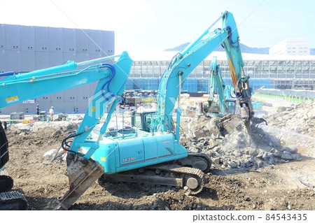 Building demolition work site with large heavy machinery demolished 84543435