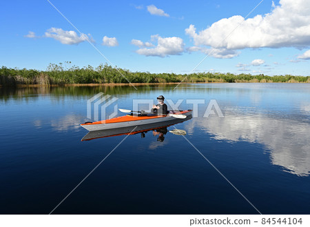 Woman kayaking on Nine Mile Pond in Everglades National Park, Florida. 84544104