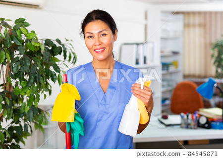 Woman wiping office floor with mop 84545871