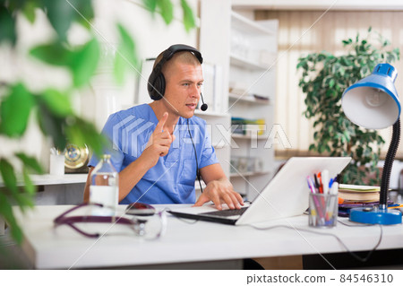 Doctor consulting patient online via laptop indoors. Telemedicine concept 84546310