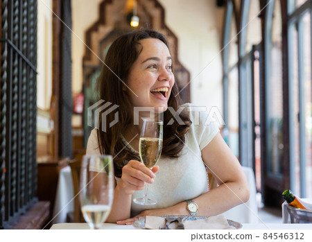 Woman sitting in restaurant, having tasty lunch 84546312