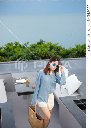 Happy woman in blue dress and sunglasses. Freedom, relaxing, vacation holiday and summer travel concept Happy woman in blue dress and sunglasses. Freedom, relaxing, vacation holiday and summer travel concept 84548055