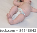 belarus,minsk,2021.brand diapers are worn on the baby lying on the crib 84548642