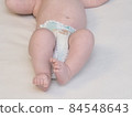 belarus,minsk,2021.brand diapers are worn on the baby lying on the crib 84548643
