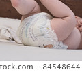 belarus,minsk,2021.brand diapers are worn on the baby lying on the crib 84548644