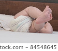 belarus,minsk,2021.brand diapers are worn on the baby lying on the crib 84548645