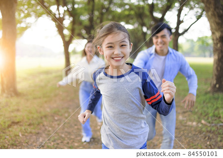 Happy Family running and playing together park Happy Family running and playing together park 84550101