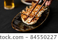 Photo of separating dumplings with chopsticks 84550227