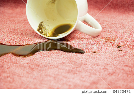 A stain on a light fabric, tablecloth, sofa. Washing, cleaning the fabric from stains. 84550471