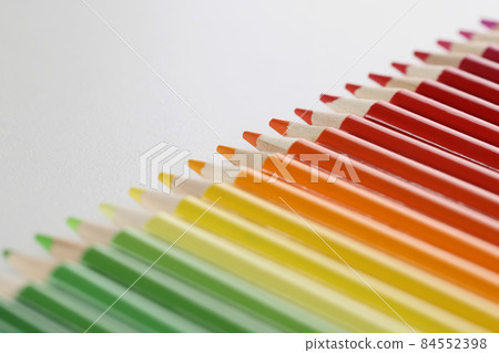 Pencils set perfectly placed in line on white surface for childs art 84552398