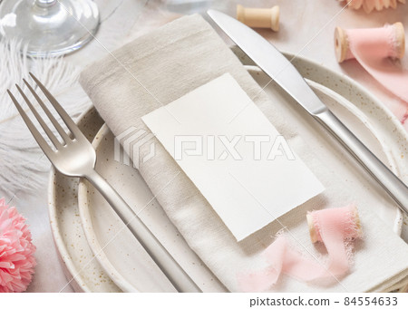 Wedding Table place with a card over napkin near flowers, silk ribbons and feathers, mockup Wedding Table place with a card over napkin near flowers, silk ribbons and feathers, mockup 84554633