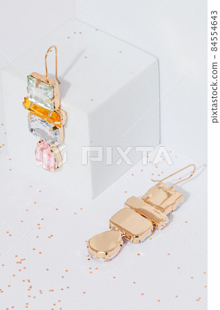 earrings with stones on a white cube background vertical orientation earrings with stones on a white cube background vertical orientation 84554643