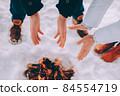 Man and woman warm their hands near fire. winter theme 84554719