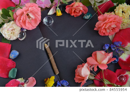 Still life with open diary with black pages, flowers, crystals and copy space, top view. Esoteric, gothic and occult background, Halloween mystic concept. Still life with open diary with black pages, flowers, crystals and copy space, top view. Esoteric, gothic and occult background, Halloween mystic concept. 84555954