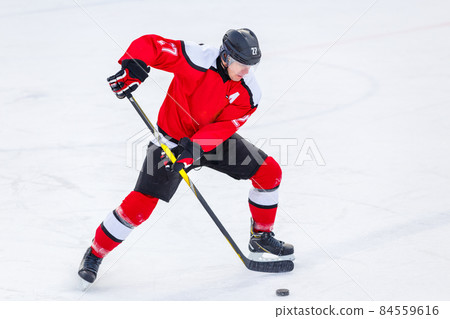 Professional ice hockey player in attack on the rink Professional ice hockey player in attack on the rink 84559616