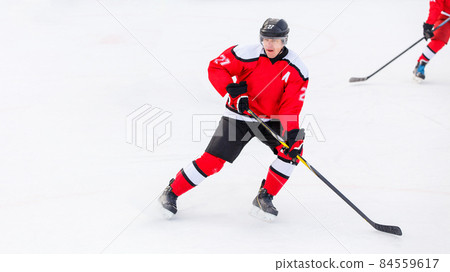 Professional ice hockey player on defending position on the rink Professional ice hockey player on defending position on the rink 84559617