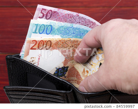 Qatari money in the black wallet. Qatari money in the black wallet. 84559997