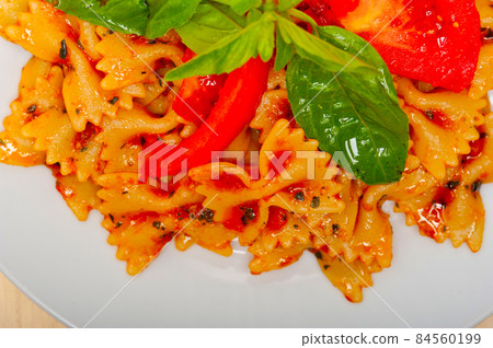 Italian pasta farfalle butterfly bow-tie and tomato sauce 84560199