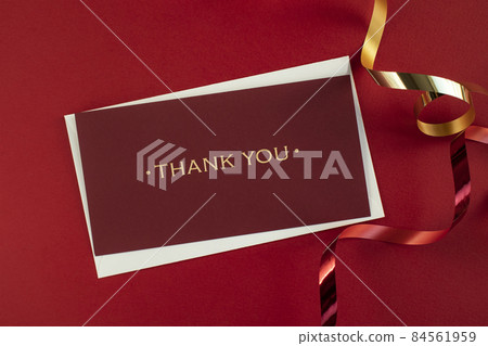Ribbon and letter of appreciation on red background 84561959