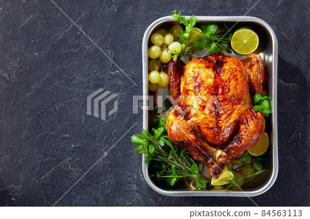 whole roast chicken in a baking dish whole roast chicken in a baking dish 84563113