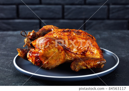 whole roast chicken, turkey on a plate whole roast chicken, turkey on a plate 84563117