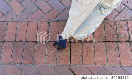 Men in work clothes checking for deterioration of tile pavement Men in work clothes checking for deterioration of tile pavement 84563215