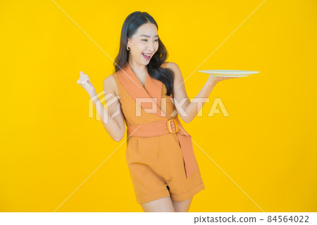 Portrait beautiful young asian woman smile with empty plate dish Portrait beautiful young asian woman smile with empty plate dish 84564022