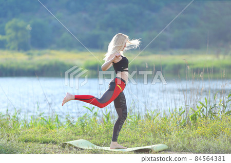Young beautiful woman squats shows result press on stomach workout training wearing top 84564381