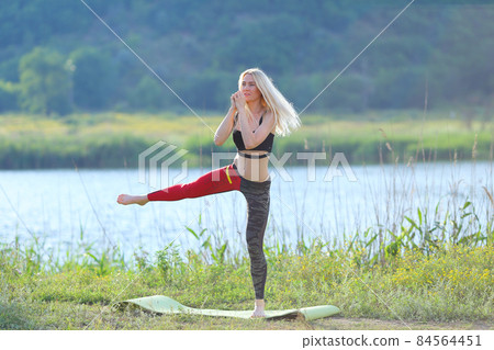 Young beautiful woman squats shows result press on stomach workout training wearing top Young beautiful woman squats shows result press on stomach workout training wearing top 84564451