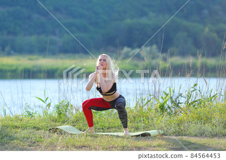 Young beautiful woman shows press stomach workout training wearing top. Young beautiful woman shows press stomach workout training wearing top. 84564453