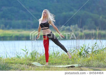 Young beautiful woman squats shows result press on stomach workout training wearing top Young beautiful woman squats shows result press on stomach workout training wearing top 84564464