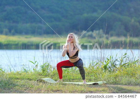 Young beautiful woman shows press stomach workout training wearing top. 84564467