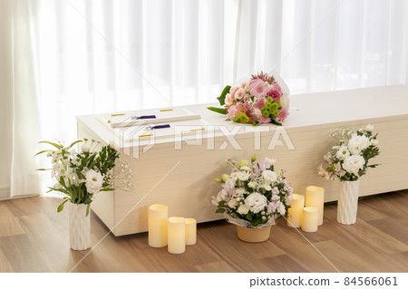 Wooden casket with a bouquet on the casket Home cremation, direct funeral, simple funeral image 84566061