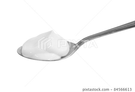 White cream on a spoon White cream on a spoon 84566613