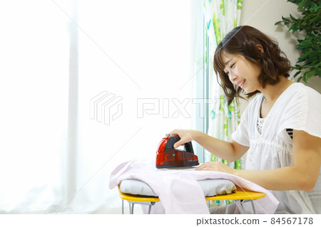 Woman ironing Woman ironing 84567178