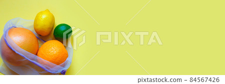 ripe juicy citrus fruitsin in reusable eco friendly bag on a yellow background 84567426