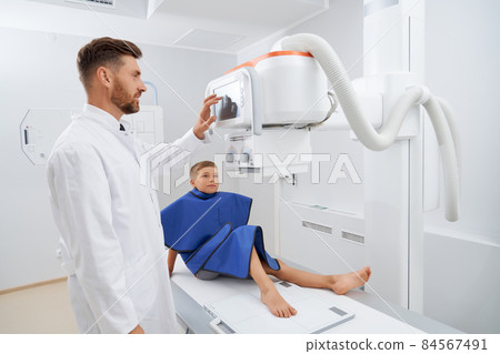 Teenager boy lie down in hospital on ultrasound diagnostic. 84567491